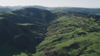 AX70_160 - 4K aerial stock footage Approach green hills with trees in Paicines, California