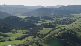 AX70_164 - 4K aerial stock footage Small green hills with trees in Paicines, California