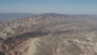AX70_204 - 4K aerial stock footage Passing a rugged desert mountains in the Caliente Mountain Range, California