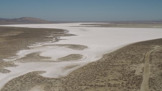 AX70_206 - 4K aerial stock footage Approach and fly over Soda Lake, California