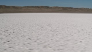 AX70_212 - 4K aerial stock footage Tilt from Soda Lake, California to reveal desert mountains