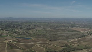 AX70_225 - 4K aerial stock footage Flyby rural homes, vineyards, and a pond in Paso Robles, California