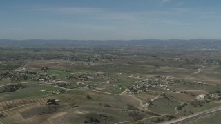 AX70_227 - 4K aerial stock footage Flyby rural homes and vineyards, reveal State Route 46 in Paso Robles, California
