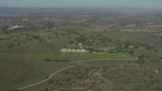 AX70_228 - 4K aerial stock footage small airfield beside an upscale home in Paso Robles, California