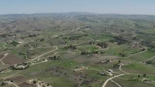 AX70_230 - 4K aerial stock footage Passing rural homes in San Miguel, California
