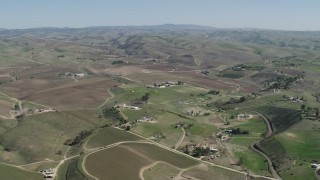 AX70_232 - 4K aerial stock footage Flying by rural homes and vineyards in San Miguel, California