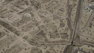 AX70_238 - 4K aerial stock footage Bird's eye of rigs in an oil field in San Ardo, California