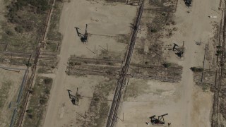 AX70_239 - 4K aerial stock footage Bird's eye view of three oil rigs in San Ardo, California