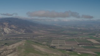 AX70_241 - 4K aerial stock footage Approach a cloud over farm fields in Greenfield, California