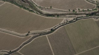 AX70_248 - 4K stock footage aerial video bird's eye view of a river by crop fields, reveal Arroyo Seco Road in Greenfield, California
