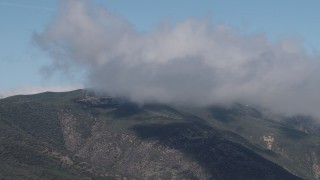 AX70_256 - 4K aerial stock footage of A cloud over a Santa Lucia Range mountain in California