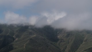 AX70_261 - 4K aerial stock footage Flyby cloud-capped Santa Lucia Range mountains in California