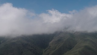 AX70_262 - 4K aerial stock footage flyby cloud-capped mountains in the Santa Lucia Range, California
