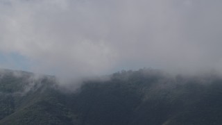 AX70_267 - 4K aerial stock footage of dense clouds over a Santa Lucia Range mountain ridge in California
