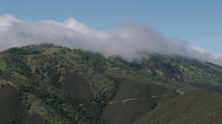 AX70_272 - 4K aerial stock footage of cloud cover over green mountains in the Santa Lucia Range in California