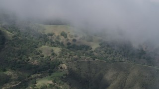 AX70_277 - 4K aerial stock footage of misty clouds over green slopes in the Santa Lucia Range in California