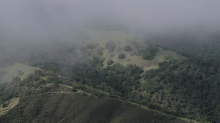 AX70_278 - 4K aerial stock footage of misty clouds above green slopes in the Santa Lucia Range in California