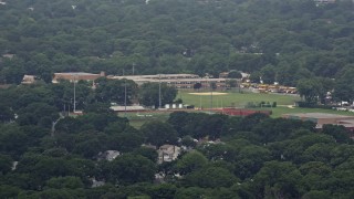 AX71_004 - 5.1K stock footage aerial video flying by Seaford High School and football fields, Seaford, Long Island, New York