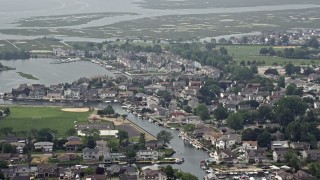 AX71_005 - 5.1K aerial stock footage of waterfront homes and canals in Seaford, Long Island, New York