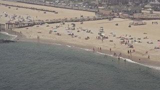 AX71_066 - 5.1K aerial stock footage of sunbathers and boardwalk on the beach in Ocean Grove, Jersey Shore, New Jersey