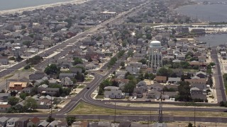 AX71_102 - 5.1K aerial stock footage of neighborhoods around a water tower in Seaside Heights, Jersey Shore, New Jersey