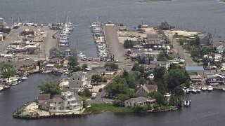 AX71_132 - 5.1K aerial stock footage of Mariner's Marina and waterfront homes in Barnegat Township, New Jersey