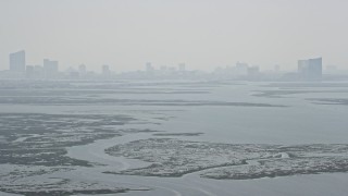 AX71_158 - 5.1K aerial stock footage tilting from Little Bay to reveal marshland and Atlantic City skyline in New Jersey
