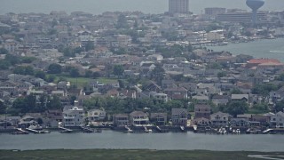 AX71_159 - 5.1K aerial stock footage of coastal neighborhoods with docks in Brigantine, New Jersey