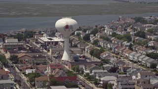 AX71_212 - 5.1K aerial stock footage of a water tower with Lucy the Margate Elephant, Margate City, New Jersey