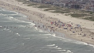 AX71_227 - 5.1K aerial stock footage of a crowded beach in Ocean City, New Jersey