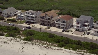 AX71_238E - 5.1K aerial stock footage flying by beachside homes in Strathmere, New Jersey