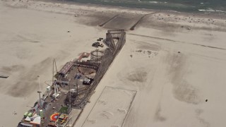 AX71_261 - 5.1K aerial stock footage a rollercoaster at Adventure Pier in Wildwood, New Jersey