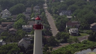 AX72_009 - 5.1K aerial stock footage of the top of Cape May Lighthouse and coastal neighborhood, New Jersey