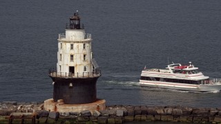 AX72_022E - 5.1K aerial stock footage orbiting the Harbor of Refuge Light, Delaware, and reveal a ferry