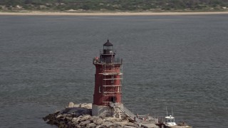 AX72_031 - 5.1K aerial stock footage flying by the Delaware Breakwater East End Light