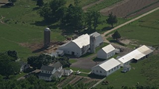 AX72_088 - 5.1K aerial stock footage approaching a farmhouse, barn, and silos in Dover, Delaware