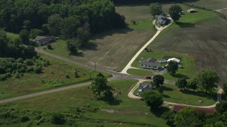 AX72_093 - 5.1K aerial stock footage of farmhouses and farmland in Henderson, Maryland