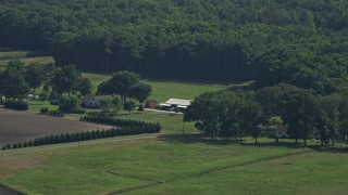 AX72_097 - 5.1K aerial stock footage of a small ranch house and barns in Henderson, Maryland