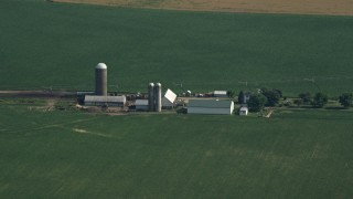AX72_103 - 5.1K aerial stock footage of barns and silos by crop fields in Ingleside, Maryland