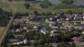 AX72_125 - 5.1K aerial stock footage of condominiums around a pond in Chester, Maryland