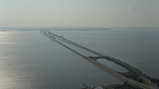 AX73_001 - 5.1K aerial stock footage flying by Chesapeake Bay Bridge spanning the bay in Maryland
