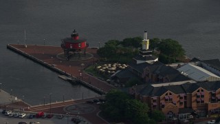 AX73_135 - 5.1K stock footage aerial video of Pier 5 Hotel Complex and the Seven Foot Knoll Lighthouse, Downtown Baltimore, Maryland