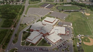 AX74_006 - 4.8K stock footage aerial video tilting to Bird's Eye of High School in Manassas, Virginia
