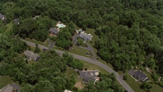 AX74_009 - 4.8K aerial stock footage flying over spacious mansions mansions and tilt to one of the homes in Clifton, Virginia