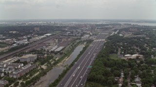 AX74_025 - 4.8K aerial stock footage of light traffic on Interstate 95 by homes in Alexandria, Virginia