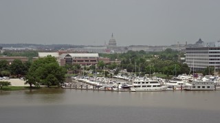 AX74_035 - 4.8K aerial stock footage of the United States Capitol in Washington DC seen from the James Creek Marina