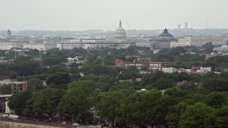 AX74_042 - 4.8K aerial stock footage of the domes of United States Capitol and Thomas Jefferson Building in Washington DC