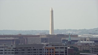 AX74_060E - 4.8K aerial stock footage of the Washington Monument seen from smoke stacks in Washington DC