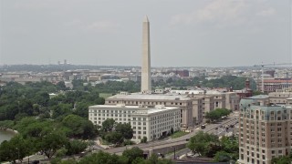AX74_069 - 4.8K aerial stock footage of Washington Monument near government office buildings on 14th Street in Washington DC
