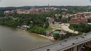 AX74_080E - 4.8K aerial stock footage flying over Francis Scott Key Bridge to approach Georgetown University in Washington DC